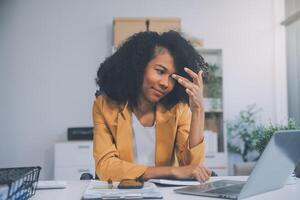 Business women are stressed while working on laptop, Tired asian businesswoman with headache at office, feeling sick at work, copy space photo