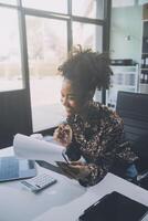 Businesswoman using calculators for do math finance on wooden desks in office and business working background, tax, accounting, statistics, and analytic research concept photo