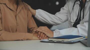 Hand of doctor reassuring her female patient photo