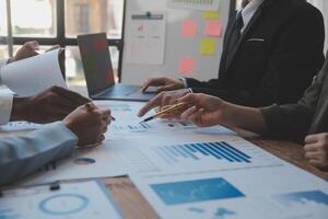 Co working conference, Business team meeting present, investor colleagues discussing new plan financial graph data on office table with laptop and digital tablet, Finance, accounting, investment. photo