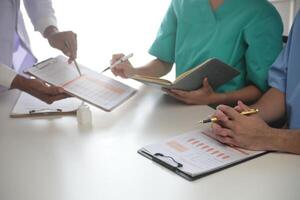 Medical Team Meeting Around Table In Modern Hospital photo