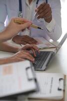 Medical Team Meeting Around Table In Modern Hospital photo