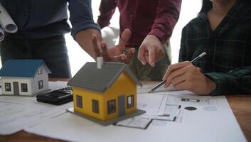 Diverse Team of Specialists Use Laptop on Construction Site. Real Estate Building Project with Engineer Investor and Businessman Checking Area, working on Civil Engineering, Discussing Strategy Plan photo