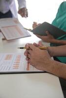 Medical Team Meeting Around Table In Modern Hospital photo