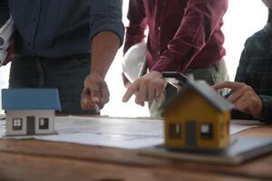 Diverse Team of Specialists Use Laptop on Construction Site. Real Estate Building Project with Engineer Investor and Businessman Checking Area, working on Civil Engineering, Discussing Strategy Plan photo