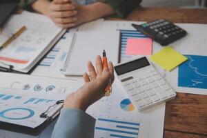 Co working conference, Business team meeting present, investor colleagues discussing new plan financial graph data on office table with laptop and digital tablet, Finance, accounting, investment. photo