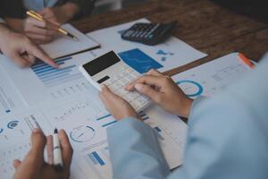 Co working conference, Business team meeting present, investor colleagues discussing new plan financial graph data on office table with laptop and digital tablet, Finance, accounting, investment. photo