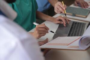 Medical Team Meeting Around Table In Modern Hospital photo