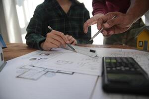 Diverse Team of Specialists Use Laptop on Construction Site. Real Estate Building Project with Engineer Investor and Businessman Checking Area, working on Civil Engineering, Discussing Strategy Plan photo