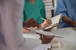 Medical Team Meeting Around Table In Modern Hospital photo