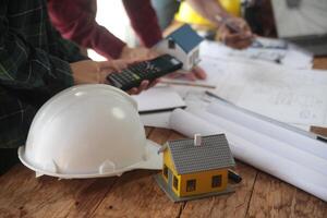 Construction and structure concept of Engineer or architect meeting for project working with partner and engineering tools on model building and blueprint in working site, contract for both companies. photo