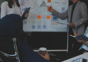 Financial analysts analyze business financial reports on a digital tablet planning investment project during a discussion at a meeting of corporate showing the results of their successful teamwork. photo