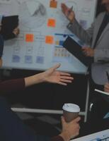 Financial analysts analyze business financial reports on a digital tablet planning investment project during a discussion at a meeting of corporate showing the results of their successful teamwork. photo