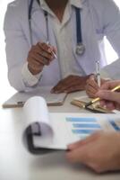 Medical Team Meeting Around Table In Modern Hospital photo