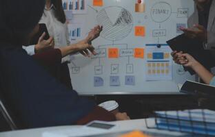 Financial analysts analyze business financial reports on a digital tablet planning investment project during a discussion at a meeting of corporate showing the results of their successful teamwork. photo