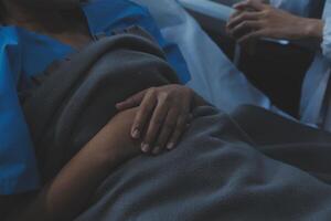 Cropped shot of a female nurse hold her senior patient's hand. Giving Support. Doctor helping old patient with Alzheimer's disease. Female carer holding hands of senior man photo