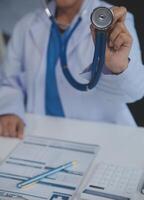 Close-up of female doctor using stethoscope , focus on stethoscope photo