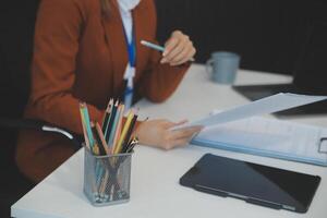 Woman sitting at desk and working at computer hands close up photo