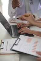 Medical Team Meeting Around Table In Modern Hospital photo