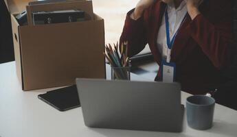 Businesswoman packing her things for move photo