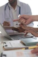 Medical Team Meeting Around Table In Modern Hospital photo