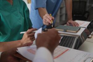 Medical Team Meeting Around Table In Modern Hospital photo