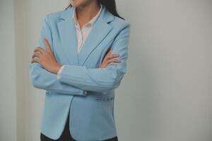 Young business arab woman isolated against a white background who feels confident, crossing arms with determination. photo