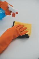 Woman cleaning table using rag and diffuser at home. photo