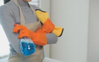 Woman cleaning table using rag and diffuser at home. photo