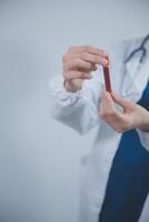 Technician, doctor, scientist in laboratory with blood sample tubes and rack In the laboratory holding a blood vessel sample for study, experiment, medical research biotechnology DNA testing. photo