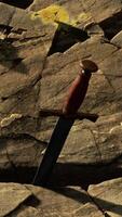 Excalibur sword in rocky stone at sunset video