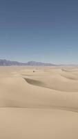 A wide expanse of sand with mountains in the distance video