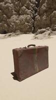 A piece of luggage sitting on top of a sandy beach video