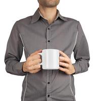 Mug in man's hand on white background photo