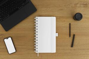 notebook and phone on top of a wooden table photo