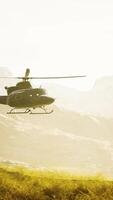 slow motion Vietnam War era helicopter in mountains video