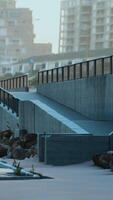 Concrete Staircase With Metal Railings Along Urban Coastline at Dusk video