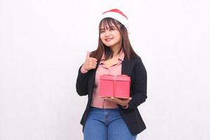 Beautiful asian girl in suit smiling with Santa Claus hat posing with Christmas gift box gift and hand signing agreement on white background for promotion, advertising, banner, billboard photo