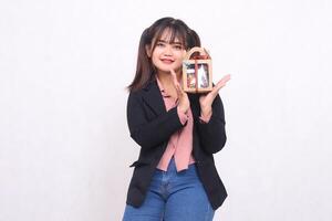 Beautiful Asian girl in her 20s smiling excitedly holding up Christmas gifts in the form of hampers looking at the camera on a white background for advertising materials, banners, billboards photo