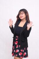 Beautiful Asian Indonesian girl in casual professional office skirt suit happy right side waving with white background for promotion, advertising, banner photo