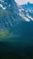 Aerial Over Valley With Snow Capped Mountains In Distance video