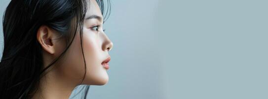 a close up of a woman s face with a gray background photo