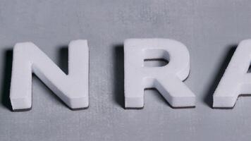 NRA National Rifle Association 3d letters close up concept light blue background video