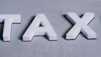 Taxes 3d letters close up light blue background video