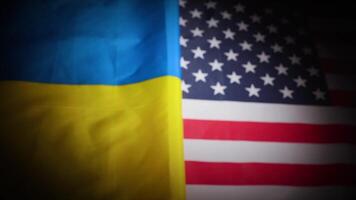 Rack focus of Ukraine and the United States national flags with vignette video