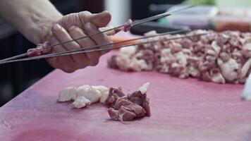 Shish Kebab Master Strings Lamb Meat on Skewers and Prepares It for Barbeque Fire Footage. video