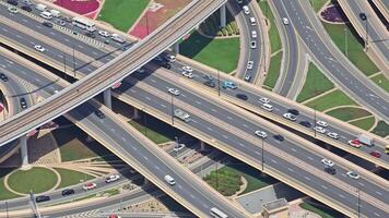 Aerial View of Busy Highway Interchange, High-angle shot of a complex highway interchange with multiple levels and lanes, showcasing the flow of traffic. video