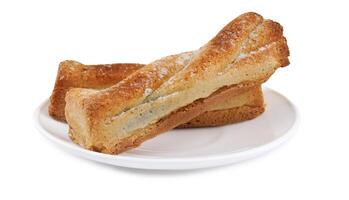 Several delicious crispy cookies lying on a white plate isolated on a white background. photo