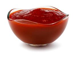 Ketchup in a glass cup isolated on a white background. Tomato sauce . photo