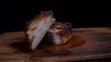 Roasted pork entrecote cut into pieces on a wooden cutting board. Grilled pork entrecote. Pork steak. photo